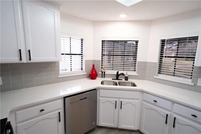 kitchen with white cabinetry, sink, backsplash, and dishwasher