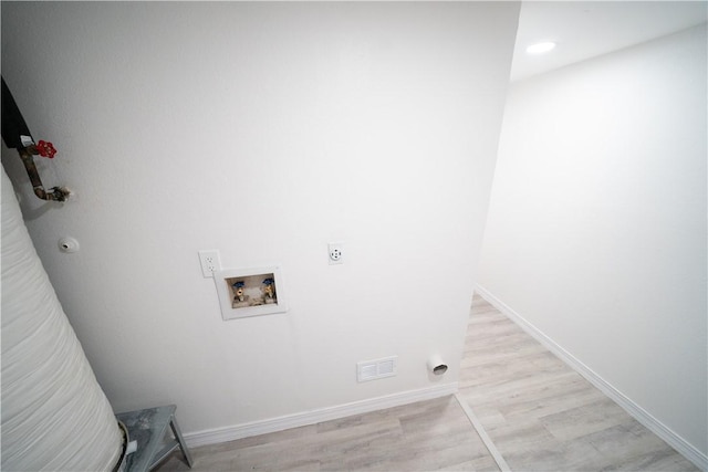 laundry area featuring electric dryer hookup, washer hookup, and light hardwood / wood-style flooring