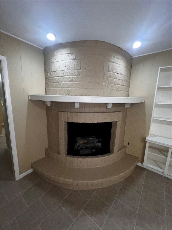 room details with tile patterned flooring and a brick fireplace