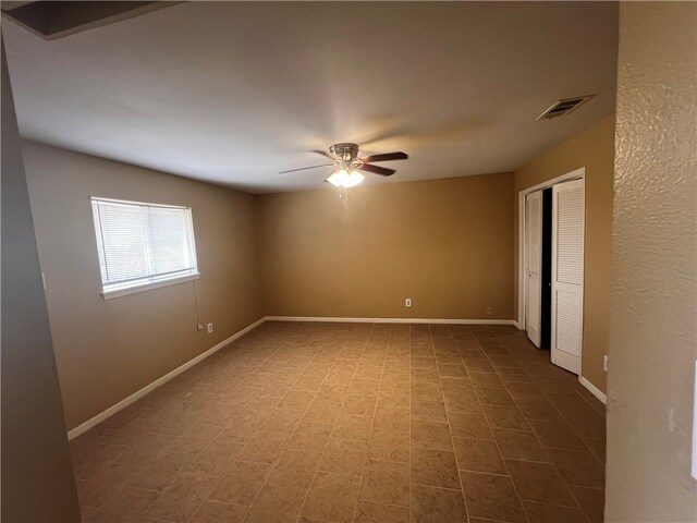 spare room featuring ceiling fan