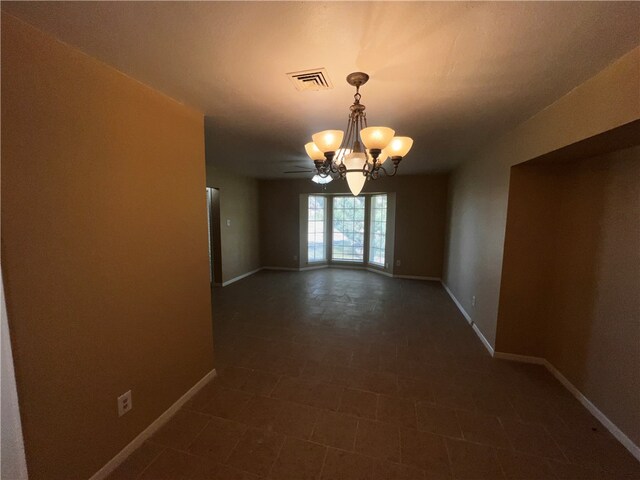 unfurnished dining area featuring a chandelier