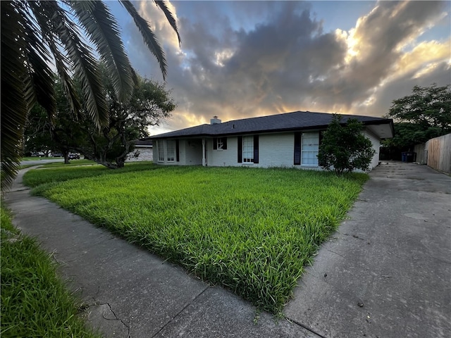 ranch-style house with a lawn