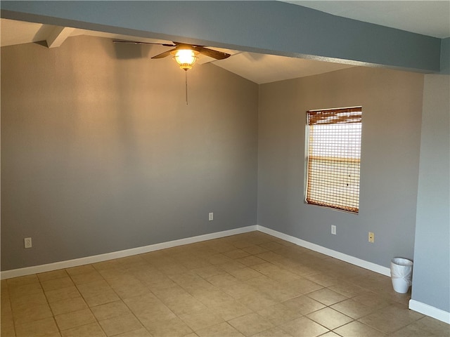 tiled empty room with beam ceiling and ceiling fan