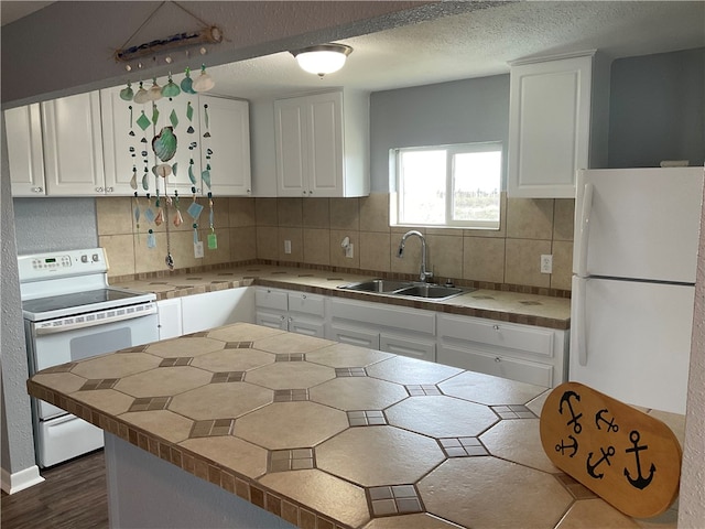 kitchen featuring white cabinetry, backsplash, white appliances, and sink