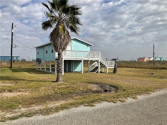 exterior space with a lawn, a deck, and a carport