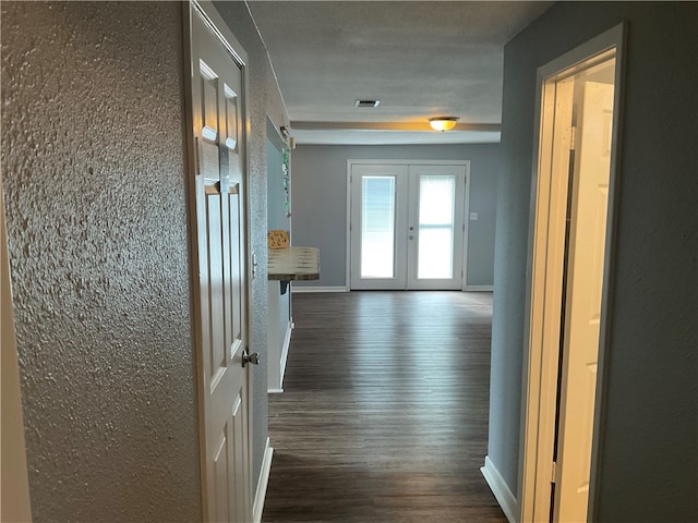 corridor featuring dark hardwood / wood-style flooring and french doors