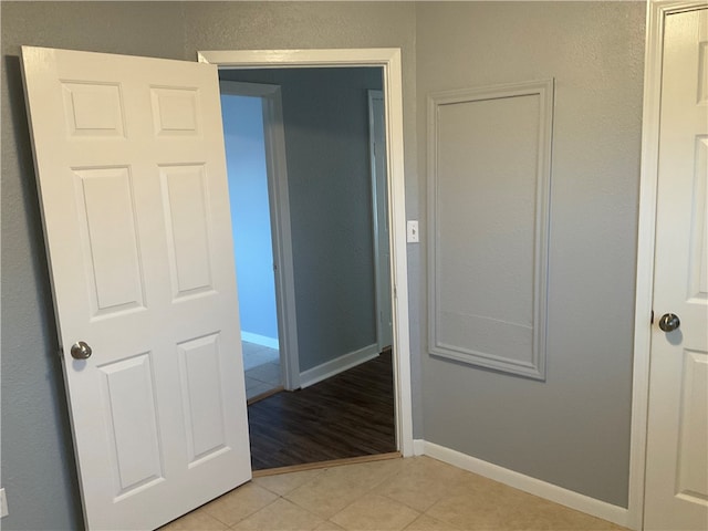 hallway with light tile patterned floors