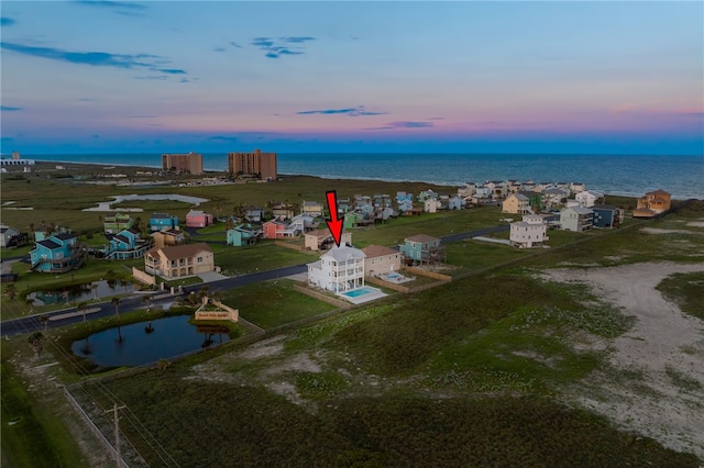 aerial view at dusk with a water view