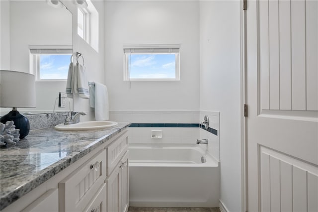 bathroom with vanity and a bathtub