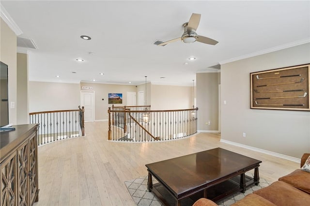 living area with ornamental molding, ceiling fan, light wood-style flooring, baseboards, and recessed lighting