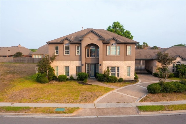 view of front of property featuring stucco siding and brick siding