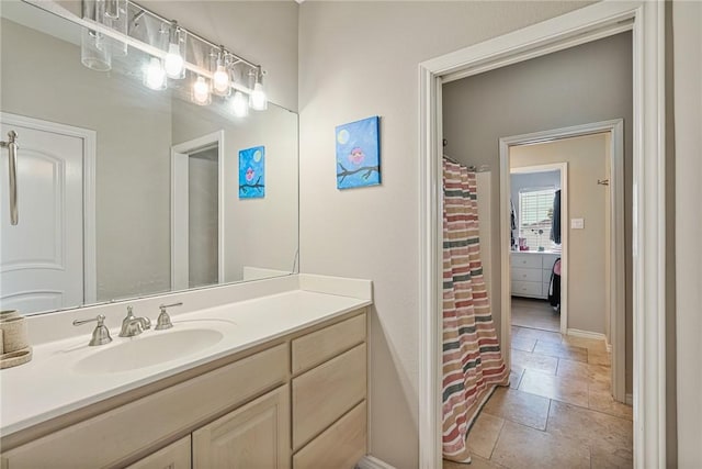 full bathroom featuring vanity, baseboards, and a shower with shower curtain
