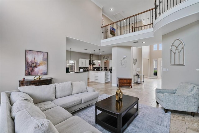 living room featuring a towering ceiling and light tile patterned floors