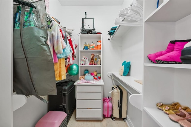walk in closet featuring light wood finished floors