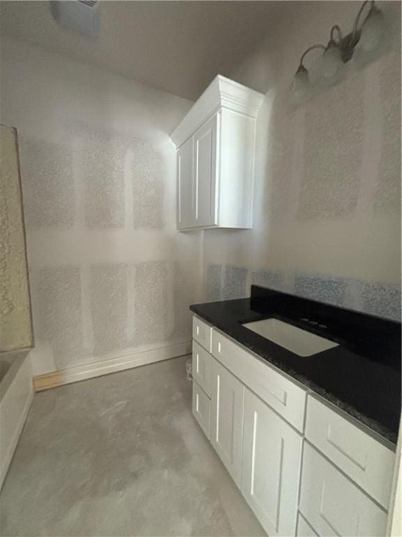 full bathroom with concrete floors and vanity