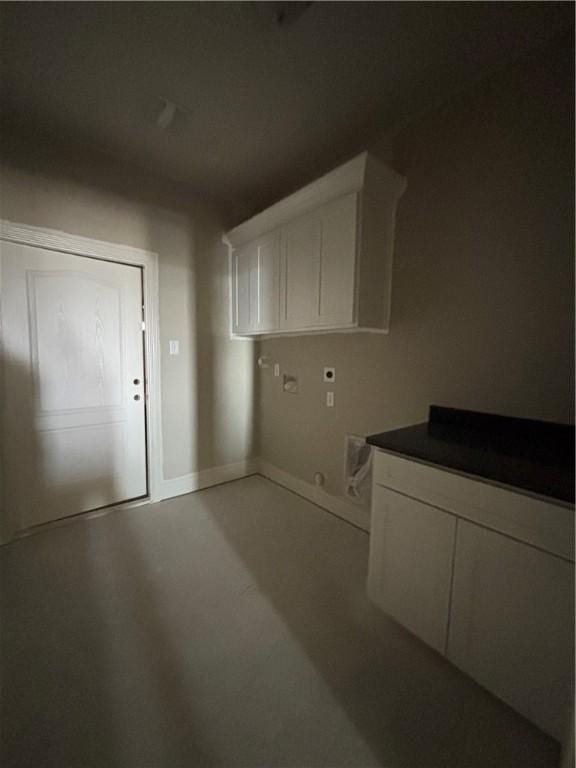 clothes washing area featuring washer hookup and cabinet space