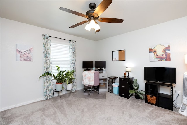 carpeted office featuring ceiling fan