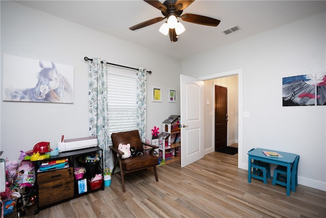 recreation room featuring light hardwood / wood-style floors and ceiling fan