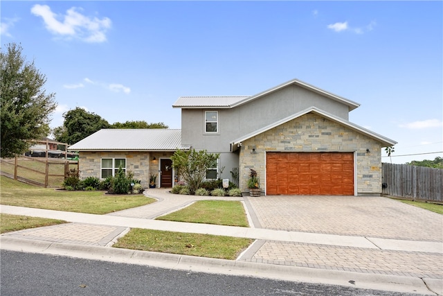 view of front facade with a garage and a front lawn