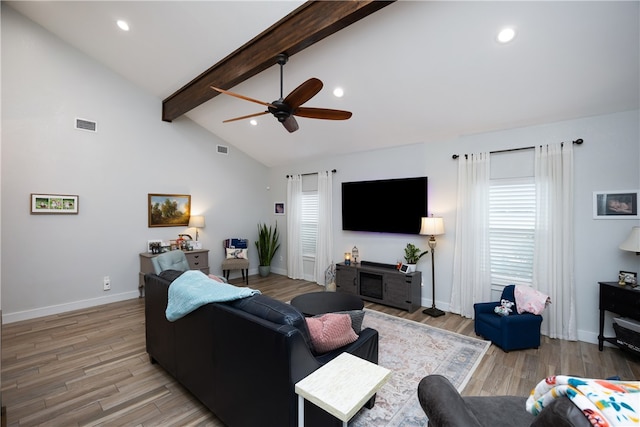 living room with ceiling fan, hardwood / wood-style flooring, and vaulted ceiling with beams