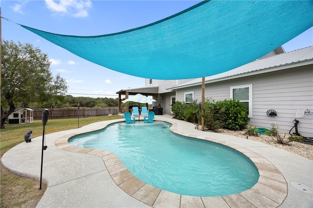 view of pool featuring a lawn and a patio area