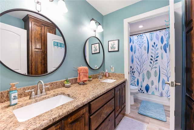 full bathroom featuring vanity, hardwood / wood-style flooring, toilet, and shower / bathtub combination with curtain