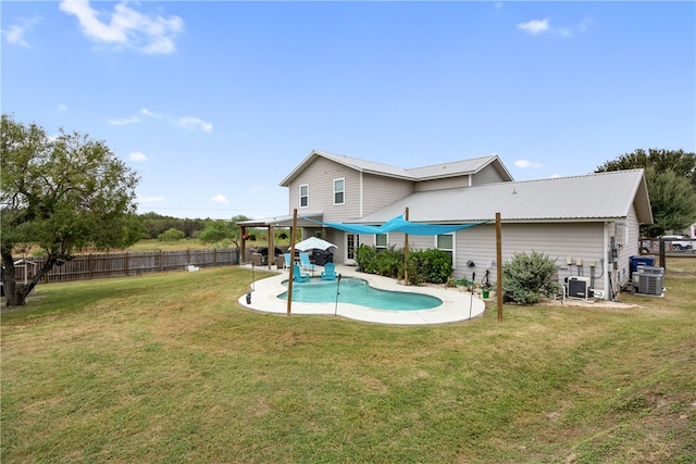 exterior space with central air condition unit, a lawn, a patio, and a fenced in pool