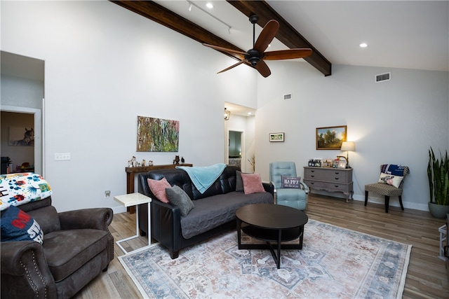 living room with high vaulted ceiling, beamed ceiling, hardwood / wood-style floors, and ceiling fan