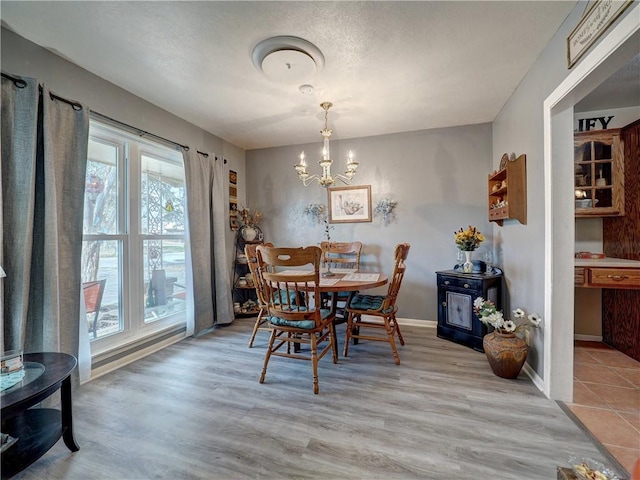 dining area with a chandelier and light wood-type flooring