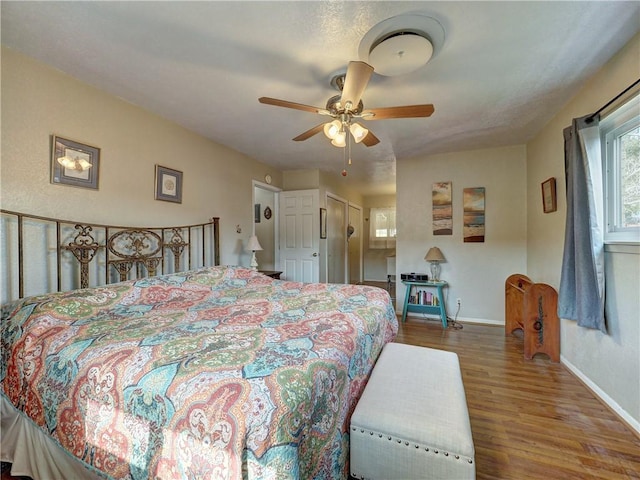 bedroom with hardwood / wood-style floors and ceiling fan