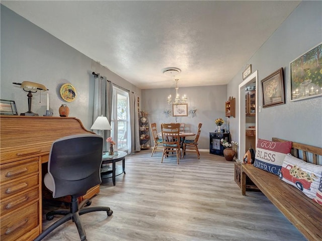 office area with a chandelier and light hardwood / wood-style flooring