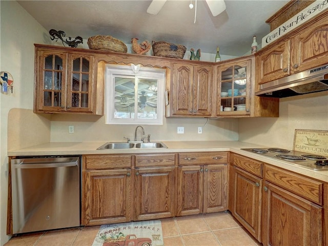 kitchen with sink, light tile patterned floors, stainless steel dishwasher, and stovetop