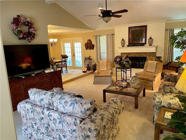 living room featuring light carpet, ceiling fan with notable chandelier, a brick fireplace, and ornamental molding