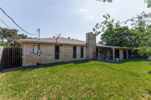 4119 Crenshaw Dr, Corpus Christi, TX 78413 - rear view of property with a chimney and a patio area
