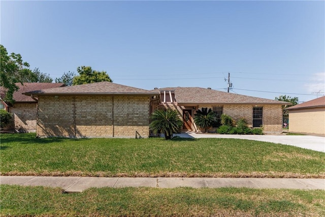 4119 Crenshaw Dr, Corpus Christi, TX 78413 - view of front of home featuring a front lawn, brick siding, and roof with shingles