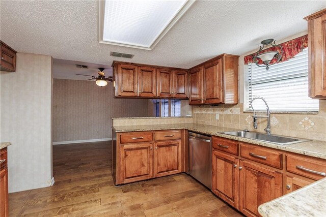 4119 Crenshaw Dr, Corpus Christi, TX 78413 - kitchen featuring a sink, dishwasher, brown cabinetry, ceiling fan, and a textured ceiling