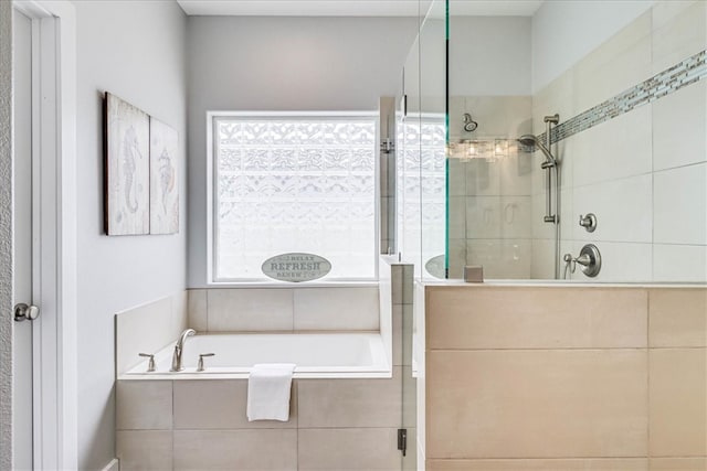 bathroom featuring separate shower and tub