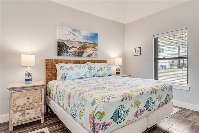 bedroom with dark hardwood / wood-style floors