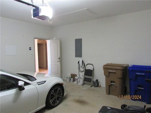 garage featuring electric panel and a garage door opener