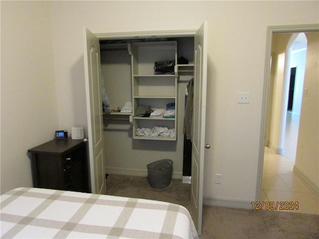 carpeted bedroom with a closet