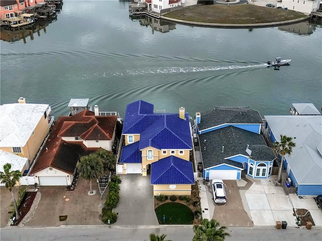 birds eye view of property with a water view and a residential view