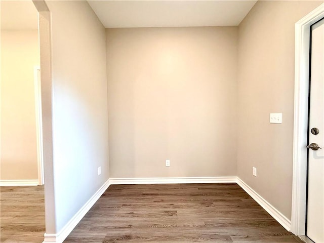1108 N Staples St, Corpus Christi, TX 78401 - unfurnished room with wood finished floors, baseboards, and arched walkways