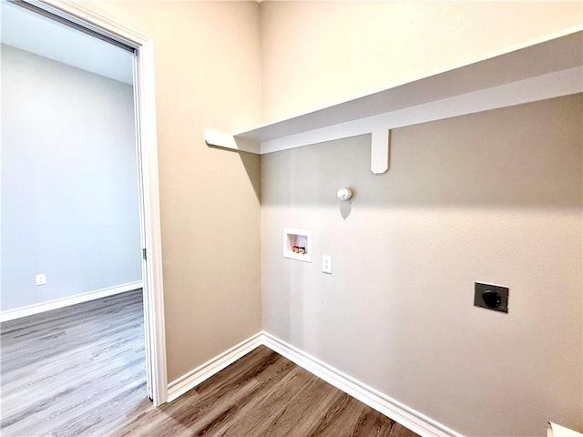 1108 N Staples St, Corpus Christi, TX 78401 - clothes washing area featuring hookup for an electric dryer, wood finished floors, hookup for a washing machine, and baseboards