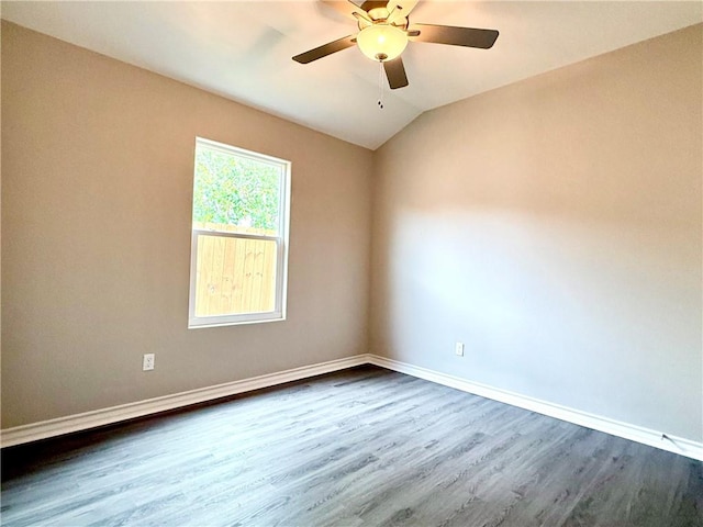 1108 N Staples St, Corpus Christi, TX 78401 - empty room featuring dark wood-type flooring, ceiling fan, baseboards, and vaulted ceiling