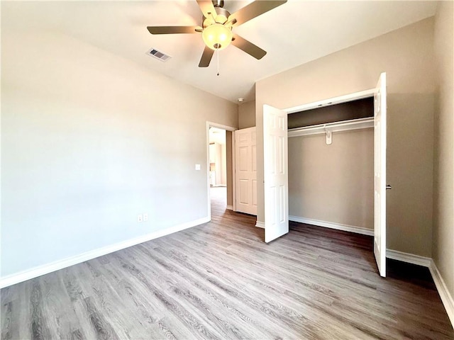 1108 N Staples St, Corpus Christi, TX 78401 - unfurnished bedroom featuring wood finished floors, a closet, baseboards, and ceiling fan