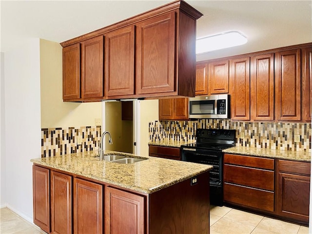 kitchen featuring electric range, sink, tasteful backsplash, light stone counters, and light tile patterned flooring