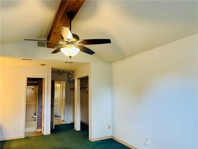 unfurnished bedroom with dark colored carpet, ceiling fan, and lofted ceiling