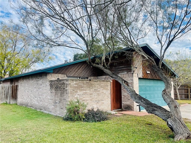 view of home's exterior with a garage and a lawn