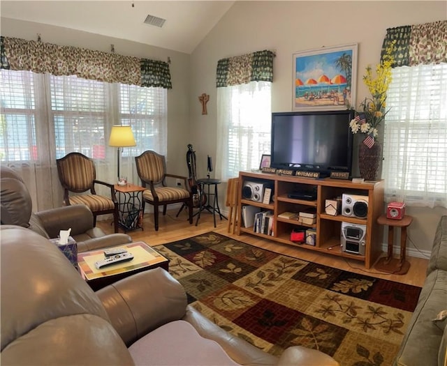 living room with lofted ceiling and hardwood / wood-style flooring