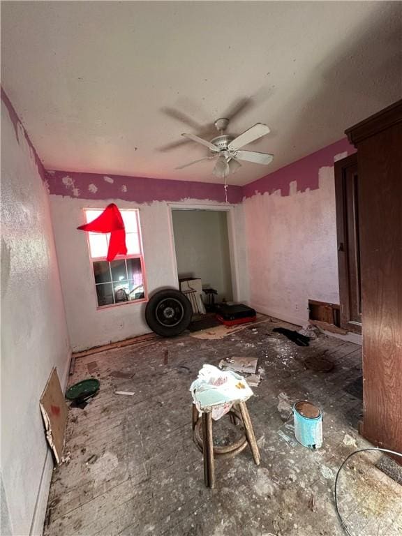 unfurnished living room featuring a ceiling fan